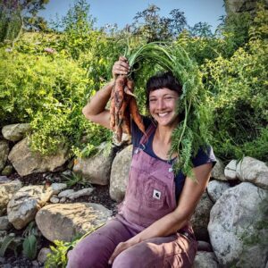 Woman smiling with a carrot